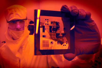 A researcher examining a photomask for a patterning sample at the Chapel Hill Analytical and Nanofabrication Laboratory at UNC-Chapel Hill. Credit: Dan Sears