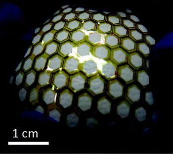 Optical image of flexible and stretchable thin film transistor array covering a baseball shows the mechanical robustness of this backplane material for future plastic electronic devices.