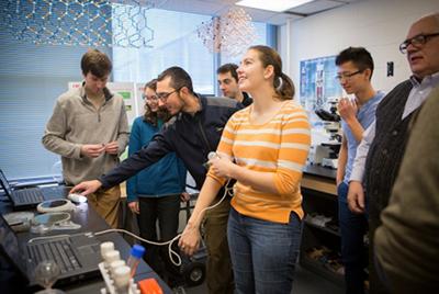 Lynn Rathbun, laboratory manager at the Cornell NanoScale Science and Technology Facility, shows engineering students how to set up demonstrations. - Lindsay France/University Photography