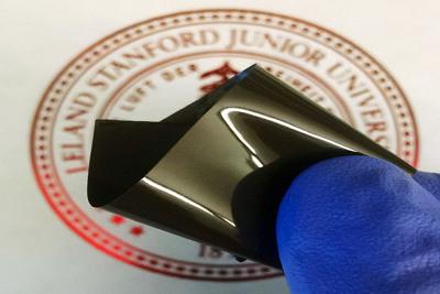 Stanford researchers have developed a thin polyethylene film that prevents a lithium-ion battery from overheating, then restarts the battery when it cools. The film is embedded with spiky nanoparticles of graphene-coated nickel. (Photo: Zheng Chen)